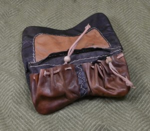 Inside of a girdle pouch, showing black and two shades of brown.